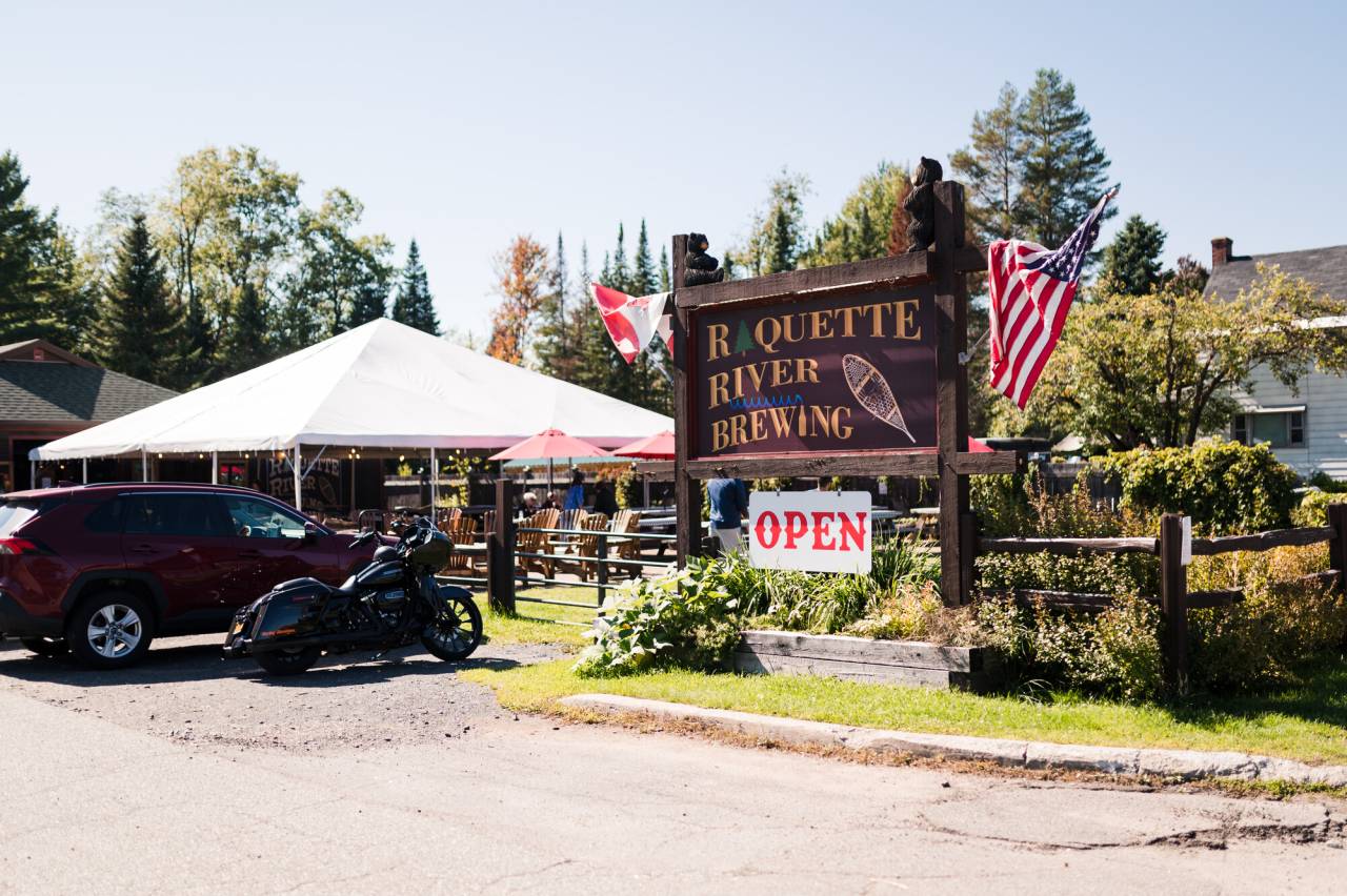 a sign to a brewery that says Raquette River Brewing.
